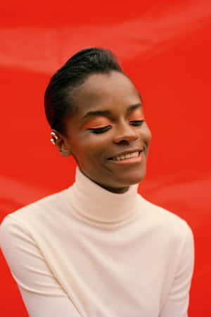 Letitia Wright Smilingin White Turtleneck Wallpaper