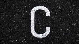 Letter C On Black Asphalt Wallpaper