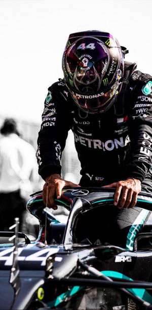 Lewis Hamilton F1 About To Sit On His Racing Car Wallpaper