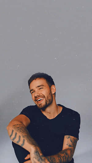 Liam Payne Having Fun On The Beach Wallpaper