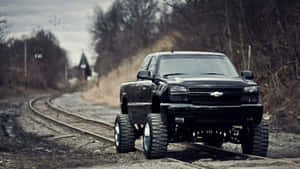 Lifted Chevrolet Truck On Railroad Tracks Wallpaper