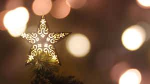 Light Up The Night With A Christmas Star Wallpaper