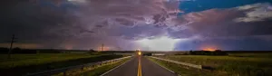 Lightning Over A Road With A Cloudy Sky Wallpaper