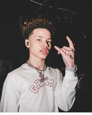 Lil Mosey Dressed In A Bright Yellow Jacket And Pants, Standing Confidently In Front Of A Grey Background. Wallpaper
