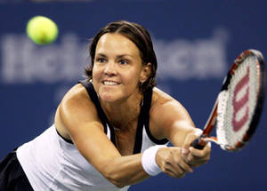 Lindsay Davenport Hitting Tennis Ball And Smiling Wallpaper