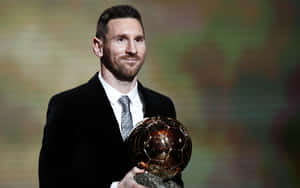 Lionel Messi Holding His 2021 Ballon D'or Trophy. Wallpaper