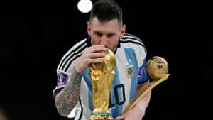 Lionel Messi Kissing World Cup Trophy Wallpaper