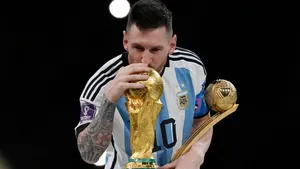 Lionel Messi Kissing World Cup Trophy Wallpaper