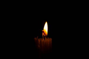 Lit Candle Dim Wallpaper