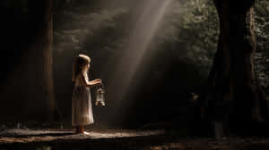 Little Girl With Lantern In Mystical Forest Light Beams Wallpaper