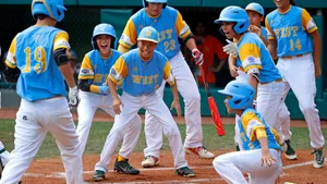 Little League Baseball Action Shot: Two Players Celebrating Victory Wallpaper