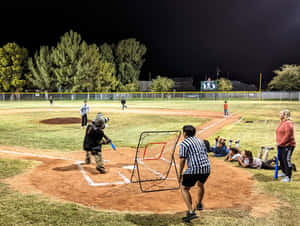 Little League Baseball Players In Action On The Field Wallpaper