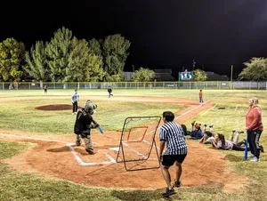 Little League Baseball Players In Action On The Field Wallpaper