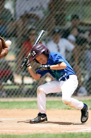 Little League Baseball Team In Action On The Field Wallpaper