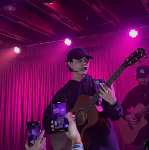 Live Music Performance Capturedon Smartphones Wallpaper
