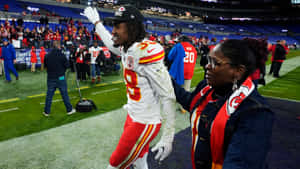 Ljarius Sneed Celebratingwith Fan After Game Wallpaper