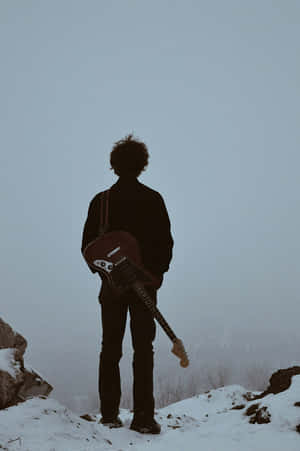 Lone_ Guitarist_ Winter_ Silhouette Wallpaper