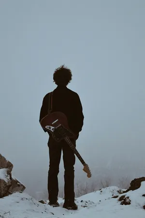 Lone_ Guitarist_ Winter_ Silhouette Wallpaper