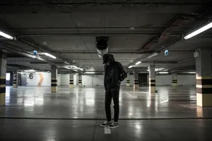 Lone Man In An Underground Parking Lot Wallpaper