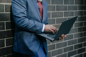 Look Confident And Professional With A Navy Blue Suit Wallpaper