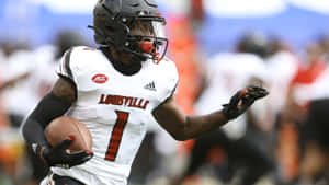 Louisville Football Player Running With Ball Wallpaper