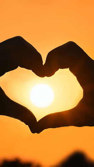 Loving Embrace: Heart Silhouette At Sunset Wallpaper