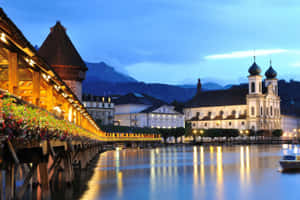 Lucerne Chapel Bridgeand Jesuit Churchat Dusk Wallpaper