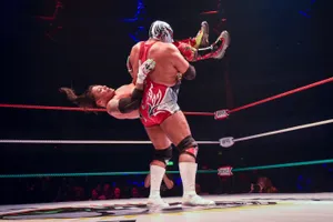 Luchador Performing Suplex Move Wrestling Match Wallpaper
