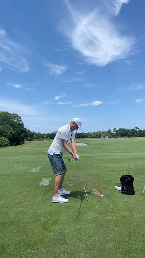 Luke Donald Performing A Golf Swing On A Sunny Day Wallpaper