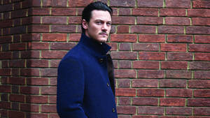 Luke Evans Brick Wall Wallpaper