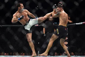 Luke Rockhold Delivers High Kick To Chris Weidman In Ufc Bout Wallpaper