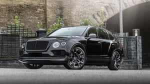 Luxurious Bentley Bentayga Suv Cruising On An Open Road Wallpaper