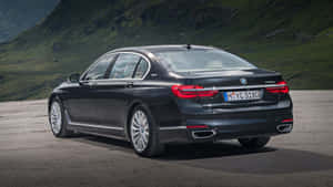 Luxurious Bmw 7 Series Cruising On An Open Road Wallpaper