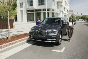 Luxurious Bmw X5 Cruising On The Open Road. Wallpaper