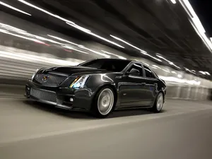 Luxurious Cadillac Cts Gliding Through The City Streets Wallpaper