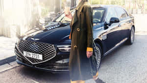 Luxurious Genesis G90 Gliding Through The City Streets Wallpaper