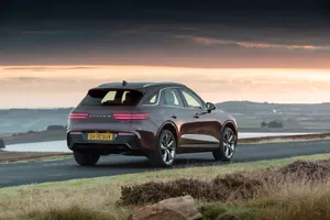 Luxurious Genesis Gv70 In Breathtaking Scenery Wallpaper