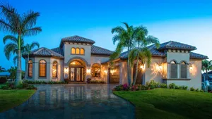Luxurious Mansion Surrounded By Lush Palm Trees Wallpaper