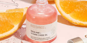 Luxurious Rose Oil In A Glass Bottle Wallpaper