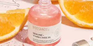 Luxurious Rose Oil In A Glass Bottle Wallpaper