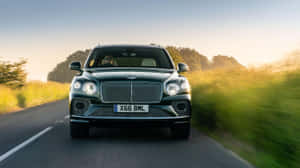 Luxury Bentley Bentayga In A Stunning Outdoor Setting Wallpaper