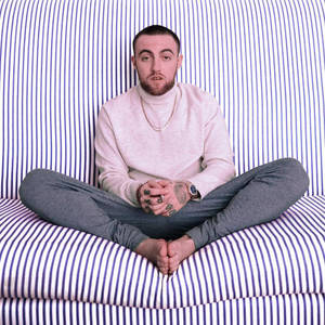 Mac Miller On Striped Sofa Wallpaper