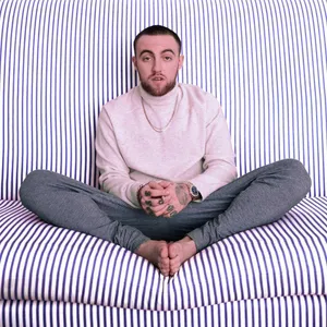 Mac Miller On Striped Sofa Wallpaper