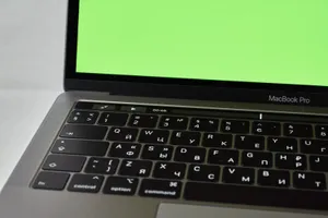 Macbook On A Green Screen Wallpaper