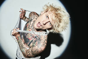 Machine Gun Kelly Under Spotlight Wallpaper