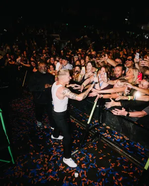 Macklemore Engagingwith Fans During Concert Wallpaper
