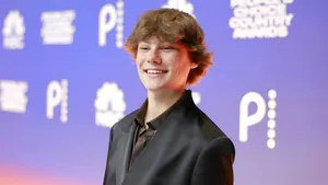 Maddox Batson Smiling At Event Wallpaper