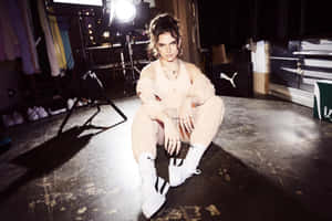 Mae Muller Performing On Stage Wallpaper