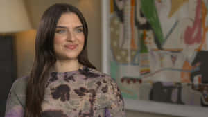 Mae Muller Striking A Pose On Stage Wallpaper