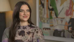 Mae Muller Striking A Pose On Stage Wallpaper